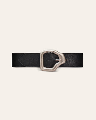 A black leather belt with a large, stylized silver-tone metal buckle, presented flat on a light cream background.
