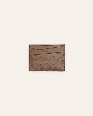 Woven brown leather cardholder on a light beige background