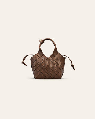 Brown woven leather handbag on a beige background