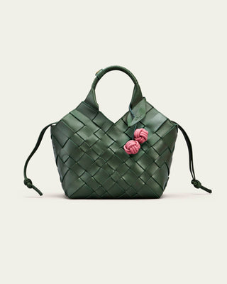 Cala Jade Misu - Green woven handbag with pink floral bag charm on a light beige background