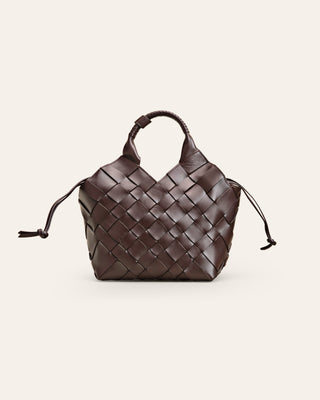 Cala Jade handbraided, brown Misu shoulder bag with a shoulder strap, zipper closure on a beige background