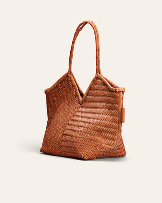 A light brown woven shoulder bag in leather used for product image on a beige background