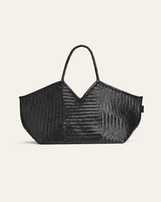A black leather tote bag with a v-shaped cutout on top and slender handles.