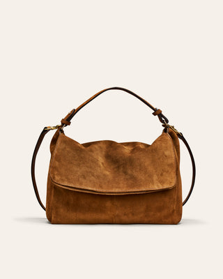 A brown suede shoulder bag with a top handle and a detachable shoulder strap, shown against a plain off-white background.
