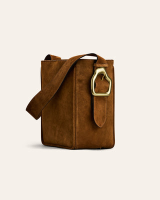 A brown suede shoulder bag with a gold buckle