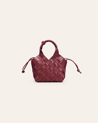Woven red handbag on a light beige background