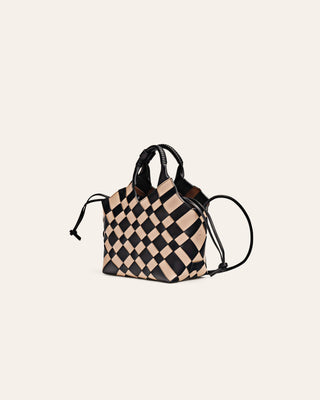Black and white checkered leather bag on a beige background