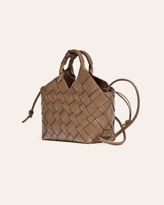 Brown woven handbag on a beige background