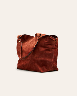 Cala Jade Red suede tote bag on a light beige background