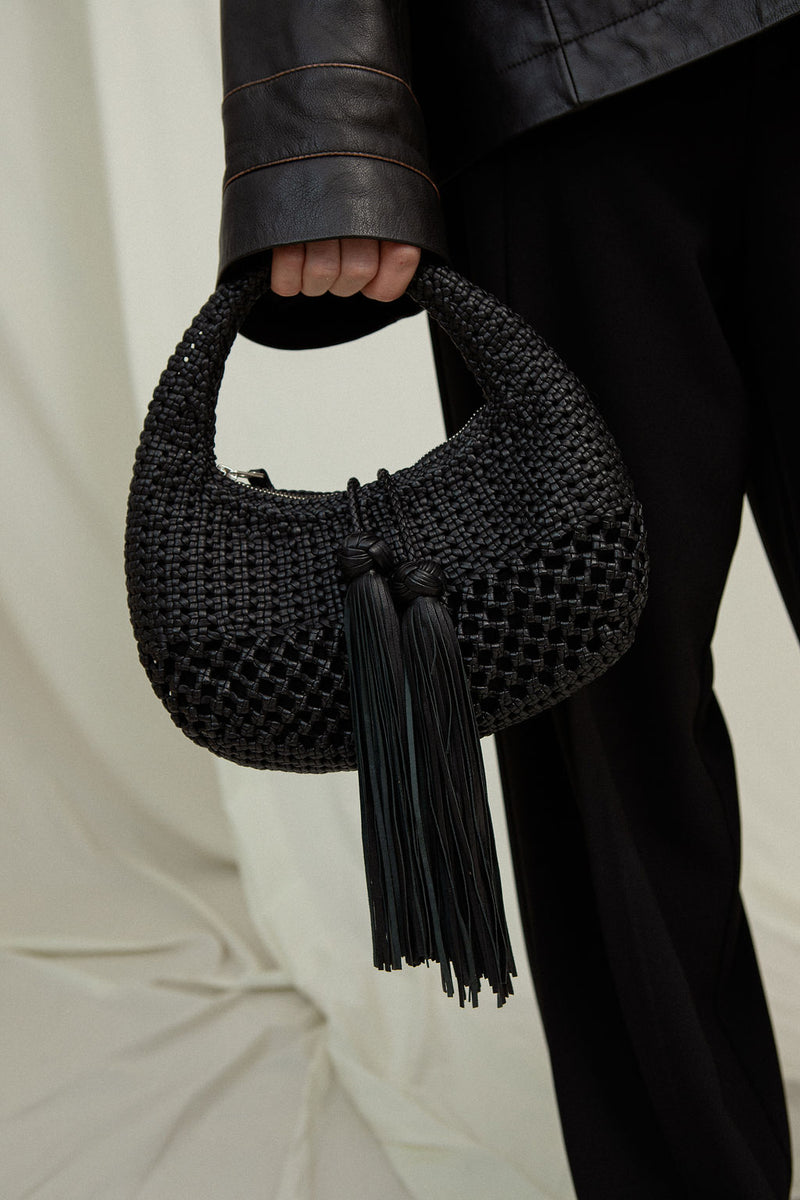 KEDI Mini Bag - hand-braided black baguette bag on model