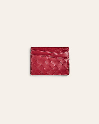 Woven red cardholder on a light beige background