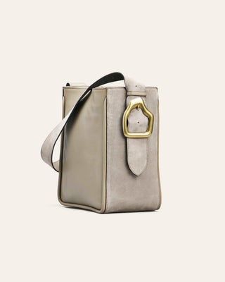 Caka Jade Masago Gray handbag with a gold buckle on a light gray background