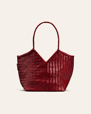 Woven red handbag on a beige background
