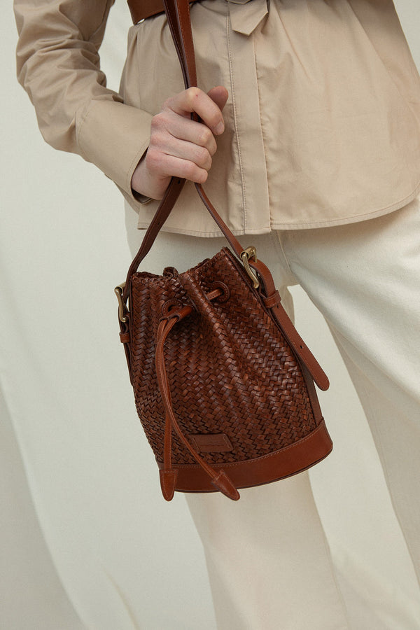 Cala Jade Gaya Mini Nutmeg Brown leather bucket bag on model 2