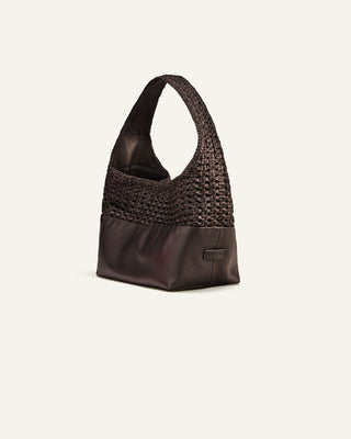 Brown handbag with woven top section on a white background