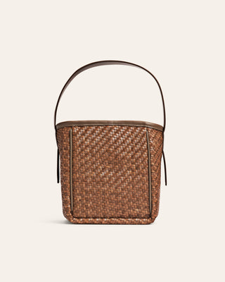 Brown woven bucket bag on a beige background