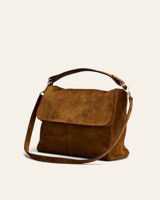 Brown suede handbag on a light beige background