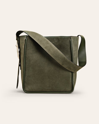 Green suede shouler bag on beige background