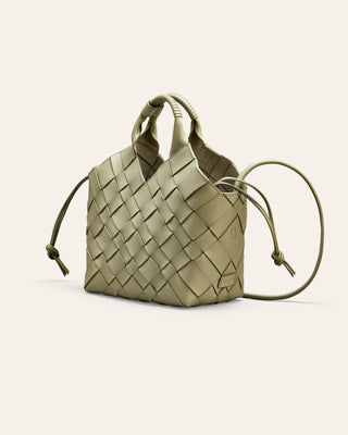 Green woven leather handbag on a light gray background