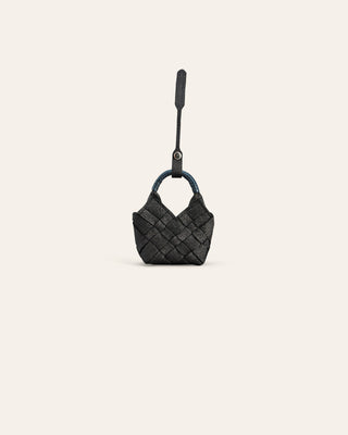 Black woven handbag charm on a light gray background