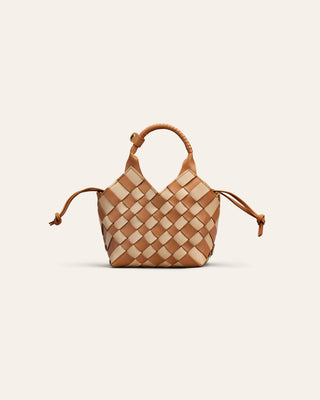 A beige and brown chess patterend shoulder bag on a beige backgroun