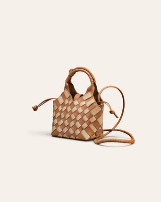 A beige and brown chess patterend shoulder bag on a beige backgroun