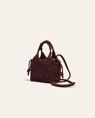 Brown woven handbag on a beige background