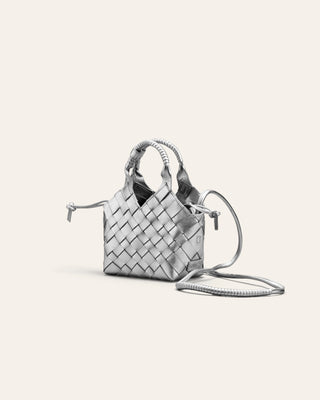 Silver leather woven handbag on a light gray background