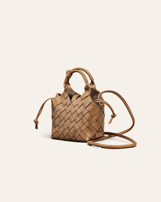 A light brown woven leather handbag on a beige background
