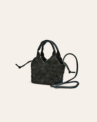 Dark Green suede woven handbag on a light beige background