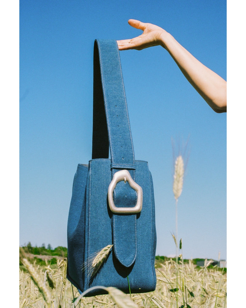 Campaign image Cala Jade Masago Tote bag in denim fabric with brass buckle