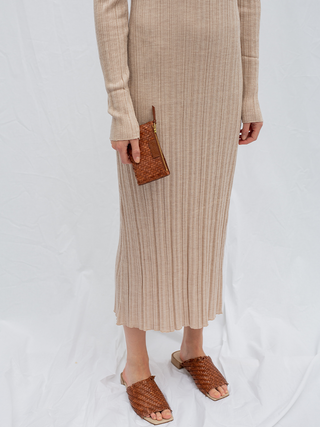 Cala Jade Caia wallet held in one hand with a model